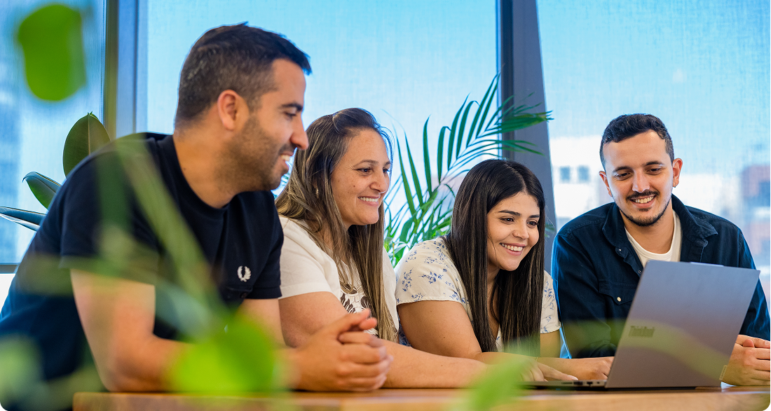 people smiling sitting with laptop
